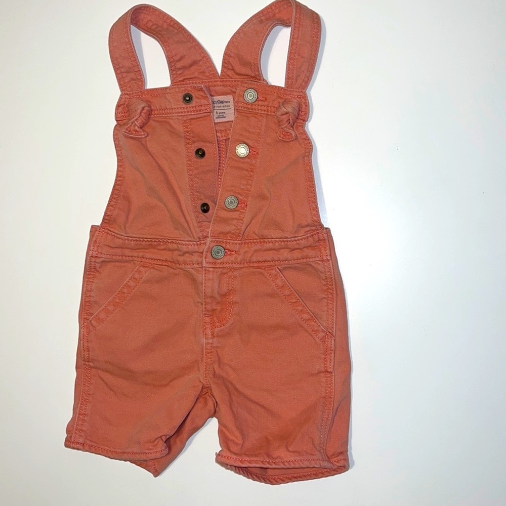 Pink denim overalls.